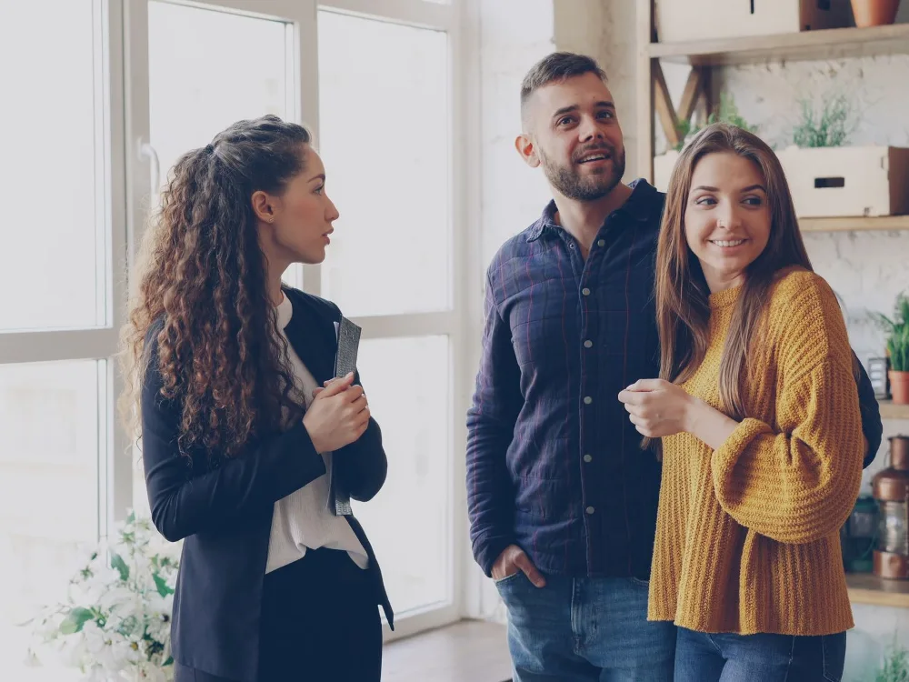 An agent showing an apartment to a couple
